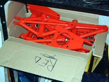 Box of red suspension bits, with superfluous comment on box!